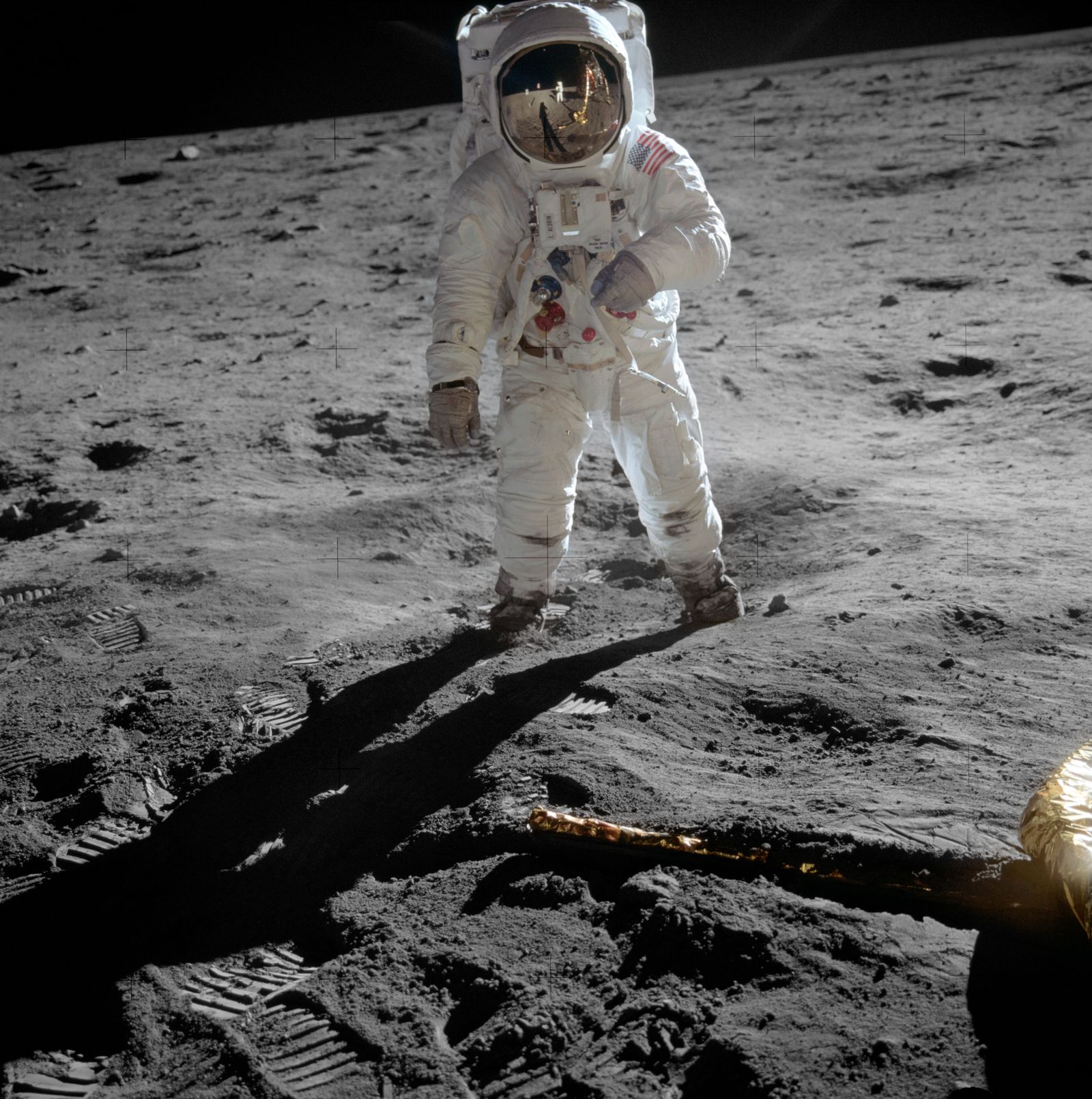 Buzz Aldrin standing beside the American flag on the Moon