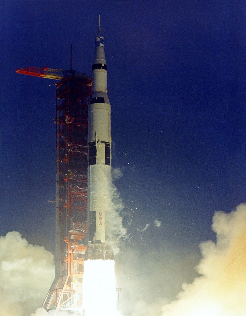Apollo 12 lifting off into a gray, rain-heavy sky