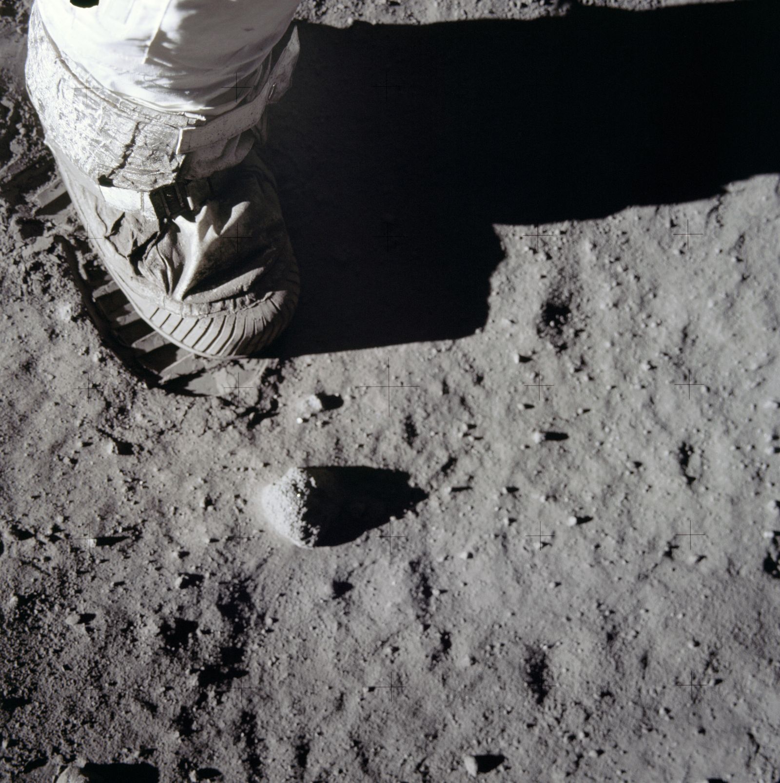 A single bootprint pressed into the lunar dust
