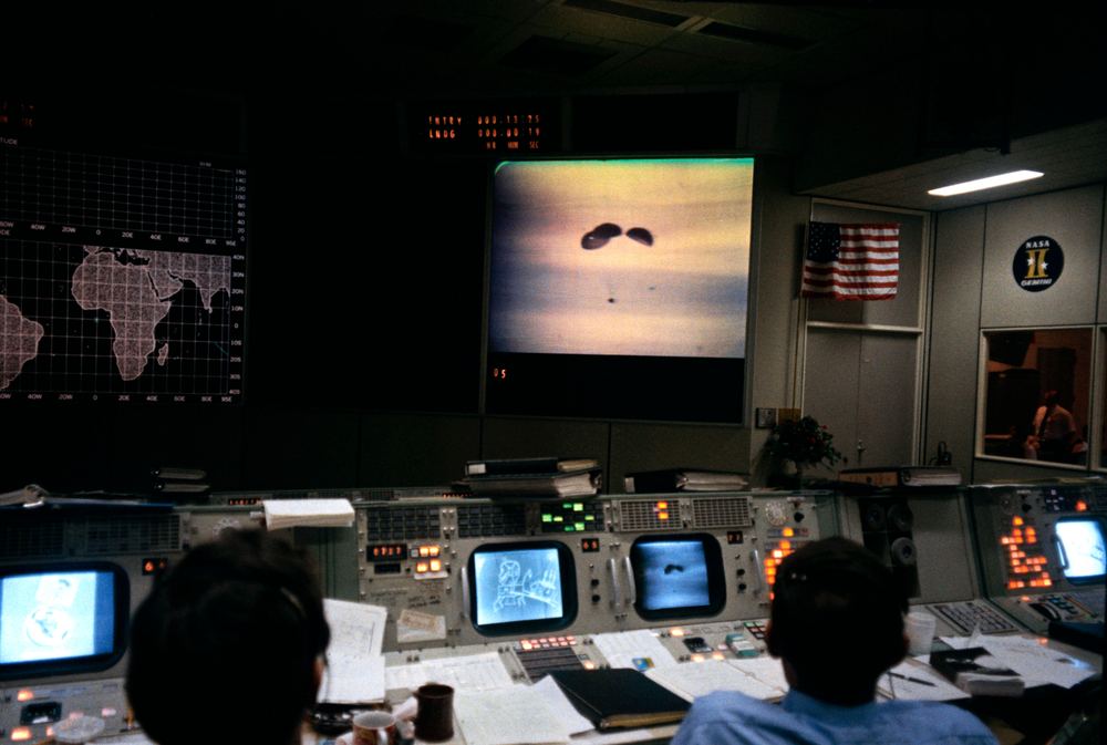 Rows of controllers at consoles in Mission Control, Houston
