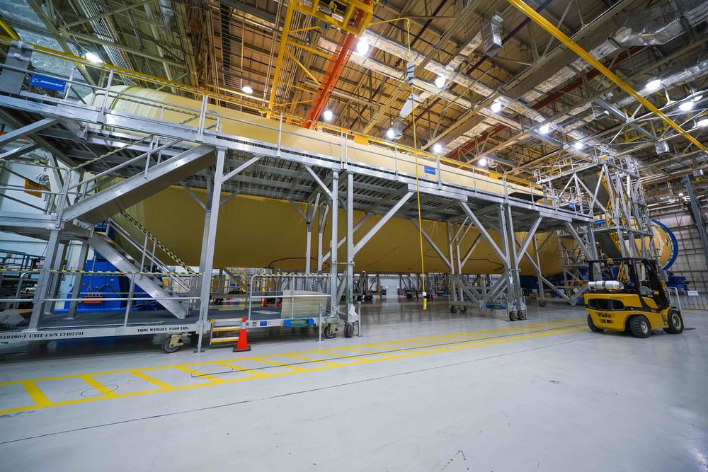 Saturn V stages under construction in a factory