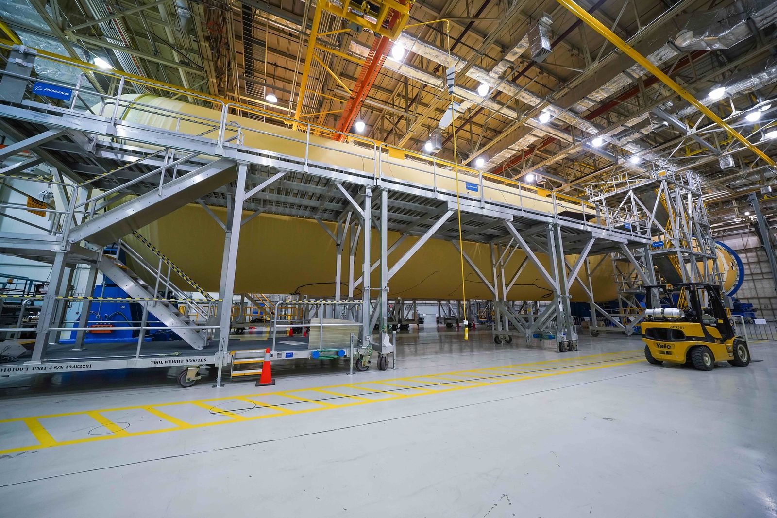 Saturn V stages under construction in a factory
