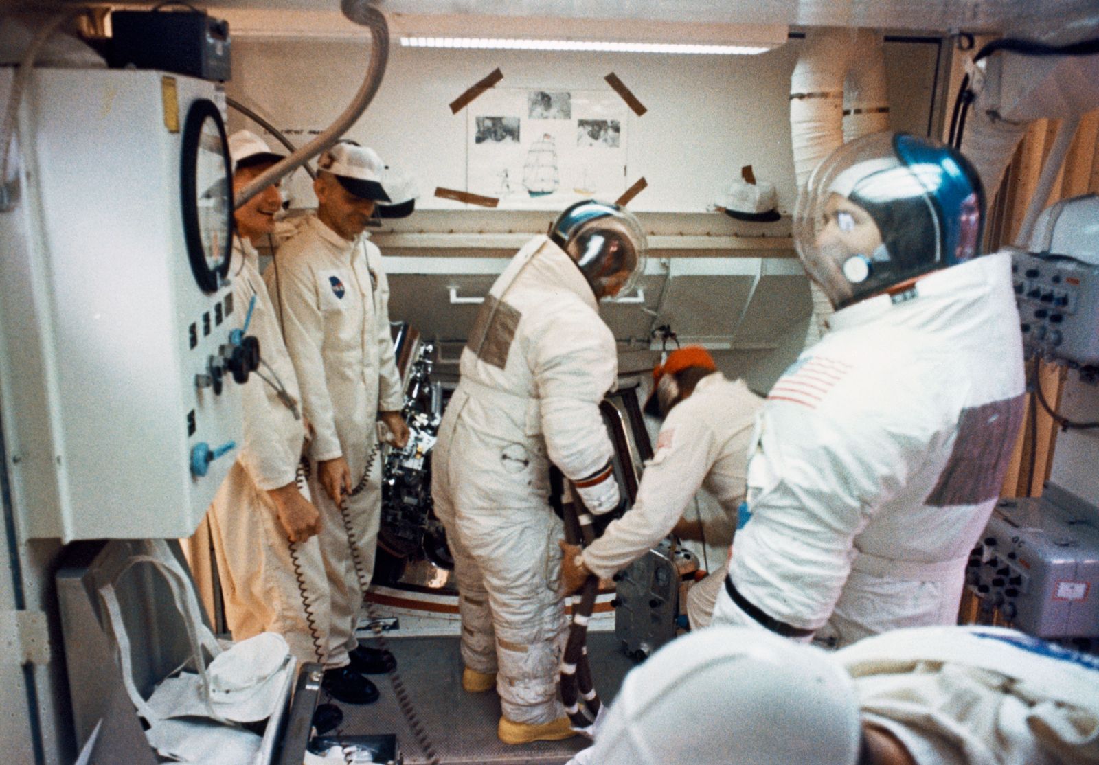 Technicians in the pad 'white room' at the top of the rocket
